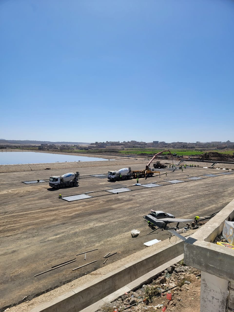 General view of reinforced concrete pouring operations using a boom pump