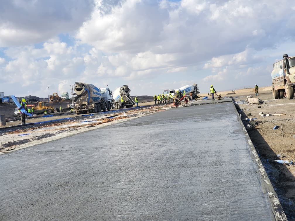 Ready-mix concrete trucks lined up at the worksite